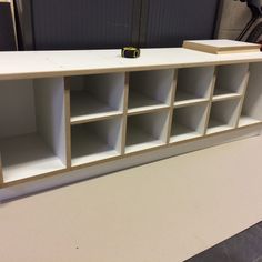 a white shelf with several open compartments on it