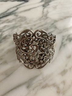 This beautiful Danecraft sterling silver very intricate cuff bracelet measures 5 3/8 inside with a 3/4" opening.  For a small to medium sized wrist.  It is somewhat adjustable to a larger wrist but will fit perfect on a 5 3/4" - 6 3/4" wrist size.  My wrist is 5.5" and it's a little big, but OK.  Tried it on a 6" wrist and was perfect.   I can make it returnable if it is prearranged, but must be returned in exact same condition and not changed the shape at all.  Bracelet is a hefty 43.2 grams and is in excellent condition, a fabulous find, made around the 1960's.      Shipping includes insurance.   As always, local pickup is available. Aphrodite's Antique & Gifts 11 Milton Ave, Highland, NY 12528 845-691-8033 Antique Sterling Silver Cuff Bracelet For Wedding, Elegant Sterling Silver Cuff Bracelet For Collectors, Unique Silver Cuff Bracelet For Anniversary, Antique Cuff Bracelet With Intricate Design For Formal Occasions, Vintage Cuff Bracelet With Intricate Design For Formal Occasions, Vintage Cuff Bracelet With Intricate Design For Formal Events, Ornate Antique Silver Sterling Bracelet For Formal Events, Ornate Cuff Bangle Bracelet For Anniversary, Ornate Cuff Bracelet With Intricate Design For Anniversary