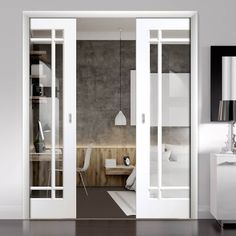 an open door leading to a bedroom with white furniture