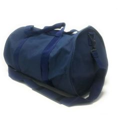 a blue duffel bag sitting on top of a white floor