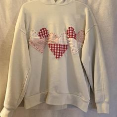 a white sweatshirt with two hearts on it