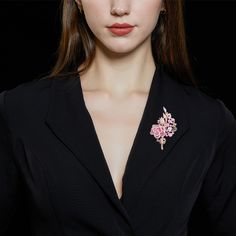 This captivating piece is a celebration of the timeless beauty of roses, brought to life with an array of dazzling stones. The brooch features a delicate rose blossom for a touch of its natural allure. Adjacent to the flower, each gracefully curved leaf adds a touch of organic charm to the design. All of the elements are adorned with an abundance of shimmering stones, carefully selected to enhance their inherent beauty. This versatile accessory can be worn on a lapel, a scarf, or as a centerpiec Elegant Flower Lapel Pin For Gift, Elegant Flower Shaped Lapel Pin For Gift, Formal Flower Lapel Pin, Elegant Flower Decorated Pins As Gifts, Elegant Flower Decorated Pins For Gifts, Elegant Flower Decoration Lapel Pin As Gift, Elegant Floral Brooch For Formal Occasions, Elegant Flower Decoration Pin As Gift, Elegant Flower Decoration Pins As Gifts