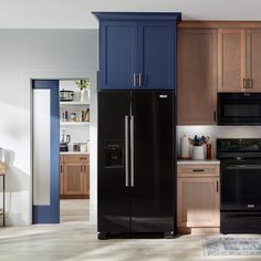 a black refrigerator freezer sitting inside of a kitchen