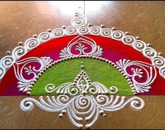 an intricately designed design on the floor with white thread and red, green and pink colors