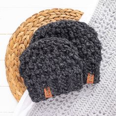 two knitted hats sitting next to each other