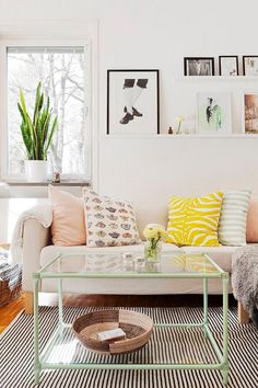 a living room filled with furniture and pictures on the wall