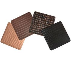 four brown and black coasters sitting on top of each other