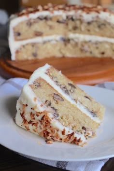 a slice of cake sitting on top of a white plate next to a wooden tray