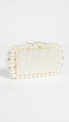 Featuring a structured, rectangular silhouette accented with bold bead trim, this Cult Gaia clutch is a polished bag from one our favorite brands for statement accessories. Acrylic Structured design with bead trim Snap closure at top Unlined Cult Gaia Clutch, Structured Design, Statement Accessories, Box Clutch, Cult Gaia, Structure Design, Beaded Trim, Eos, Snap Closure