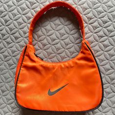 Handbag By Nike Style Size Small Orange Underarm Bag Still New 99% Never Used Casual Medium Bag With Handles, Casual Medium Shoulder Bag, Trendy Nike Travel Bag, Casual Orange Handheld Bag, Casual Orange Bag With Handles, Trendy Medium Shoulder Bag For Daily Use, Casual Orange Shoulder Bag With Handles, Trendy Medium Shoulder Bag For Shopping, Nike Rectangular Everyday Bags