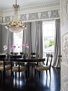 a dining room table with chairs and a chandelier