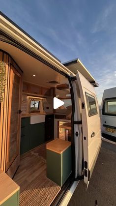 the interior of a camper van with its door open and storage area in view