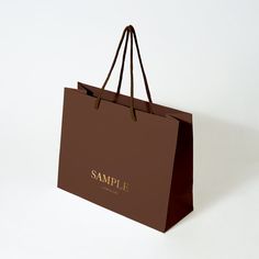 a brown shopping bag with the word sample printed on it's front and side