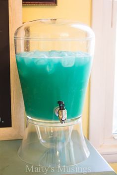 a blue liquid in a glass on top of a table