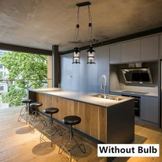 a kitchen with lots of counter space and stools in front of an open window