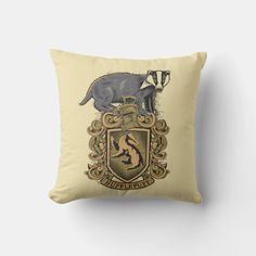 the hogwarts crest pillow is shown on a beige background with an image of a badger