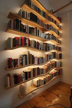 a bookshelf filled with lots of books on top of a wooden floor