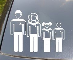 a family sticker on the side of a car with grass in the back ground