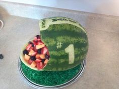 a watermelon shaped cake with fruit on top