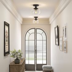 an entryway with arched glass doors and white walls