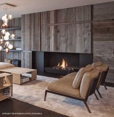 a living room filled with furniture and a fire place next to a wall mounted fireplace