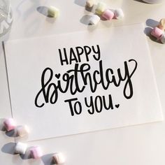 a happy birthday to you card surrounded by marshmallows and confetti