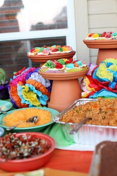 a table topped with lots of food next to pots and pans filled with food