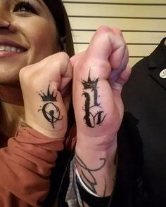 two people with matching tattoos on their hands