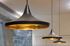 three lights hanging from the ceiling in a kitchen