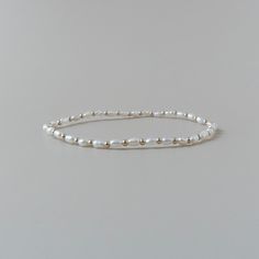 Introducing this minimalist extra dainty approx. 2.5mm genuine freshwater pearl stretch beaded bracelet, featuring 14k gold filled, rose gold filled or sterling silver accent beads. Matching ring is also available in my store. This bracelet is perfect for stacking or wearing by itself for a minimalistic look. This timeless jewelry piece will make a perfect engagement, wedding, birthday, or anniversary gift for a mother, friend, girlfriend, daughter, sister, teacher, wife, bride, bridesmaid, or yourself. It will come in a gift-ready package. Pearls are June birthstone!   Sizing: Measure your wrist and add up to 1/2 inch to the measurement for a comfortable fit. The bracelet size equals the length of the bracelet in inches, prior to tying it.  Please visit my shop, I have a wide variety of d Minimalist Beaded Bracelets With Pearl Chain, Minimalist Everyday Beaded Bracelet With Pearl Chain, Dainty Beaded Pearl Bracelet For Everyday, Minimalist Pearl Bracelets With Tiny Beads, Minimalist Beaded Bracelets With Pearl Drop, Dainty Everyday Beaded Pearl Bracelet, Minimalist Beaded Bracelet With Pearl Charm For Everyday, Minimalist Pearl Bracelet With Round Beads, Minimalist 14k Gold Filled Beaded Bracelets With Pearl Charm