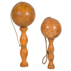 an old fashioned wooden table lamp with a cord attached to the top and one turned on