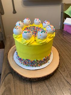 a yellow cake with sprinkles and white frosting