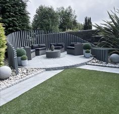 an outdoor seating area in the middle of a garden