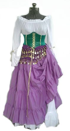 a purple and green dress on a mannequin headdress with gold accents