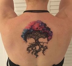 a woman with a tree tattoo on her back