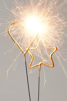 a sparkler shaped like a star on top of a stick