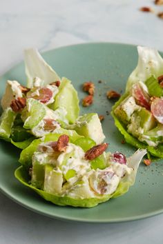 three lettuce cups filled with salad and nuts