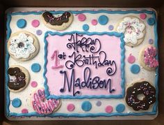 a birthday cake decorated with donuts and frosting