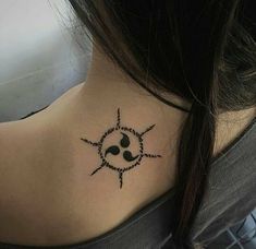 a woman's neck with a tattoo on the back of her neck and sun behind it