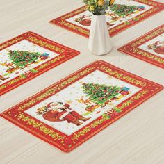 four christmas placemats on a table with flowers in a vase