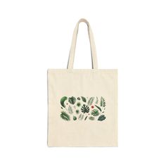 a tote bag with green leaves and berries on the front, printed in white