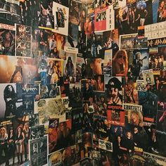 a wall covered in posters and pictures of rock bands