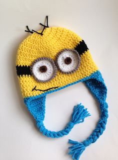 a crocheted yellow and blue hat with eyes