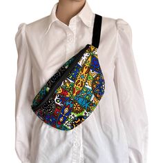 This cute bag is made with cotton African multicolored print fabric. The compartments opens with a zipper and inside completely lined with plain black  fabric. There is the main compartment and an extra pocket on the interior back side which is good for keys and cellphone. Walk or run around hands free and looking great carrying all the essentials that you need. The bright multicolored African  fabric makes it stand out and be ready to get compliments.  The bag measures approximately 7 inches hi Casual Multicolor Pouch Belt Bag, Casual Multicolor Belt Bag For Daily Use, Rave Bag, African Print Shirt, Noir Uni, Belly Bag, Cross Shoulder Bags, Banana Bag, Fanny Bag