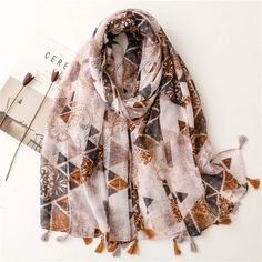 Indulge in the splendor of the season with our Autumn Couture Viscose Shawl Scarf. This high-quality piece features a striking Aztec geometric pattern, crafted from luxurious cotton viscose pashmina, and delicately wrapped in a transparent plastic bag. Available in a versatile 180*90cm size, with a weight of approximately 130g, this fashion statement is perfect for both retail and wholesale. Embrace elegance and sophistication with this exquisite addition to your wardrobe. (Product size: 180cm*90cm; please note that there may be slight measurement discrepancies due to manual handling.) Corduroy Skirt Outfit, Boho Hair Wrap, Kimono Coat, Boho Fashion Summer, Polyester Scarf, Scarf Material, Muslim Hijab, Hijab Scarf, Shawl Scarf