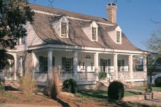 a large white house with two stories and a porch