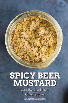 spicy beer mustard with roasted match chili peppers in a glass jar on a blue background