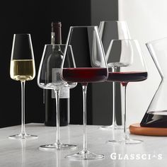 several wine glasses are lined up on a table