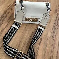 Well Loved Bag. White Leather (Could Be Detailed Like New) Fun Strap With New Clasps Comes With Original. Moschino Handbags, Moschino Bag, Moschino Bags, White Leather, Moschino, Crossbody Bags, Color White, Bag Lady, Like New