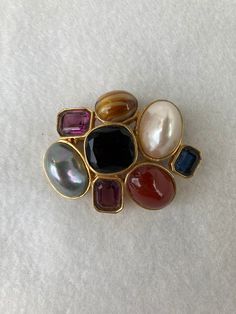 "Measuring 1 1/3\" wide this whimsical brooch is 1 1/2\" tall. It is in excellent condition and is clearly marked on the back." Elegant Oval Multi-stone Brooches, Elegant Multi-stone Oval Brooches, Elegant Multi-stone Oval Brooch, Multicolor Cabochon Brooches For Collectors, Formal Multicolor Gemstone Brooches, Vintage Gemstone Brooches For Formal Occasions, Unique Multicolor Cabochon Brooches, Elegant Multicolor Gemstone Brooches, Collectible Multicolor Costume Jewelry Brooches